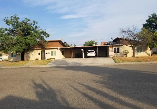 ranch-style home with a carport and driveway