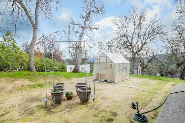 view of yard featuring an outbuilding and a greenhouse