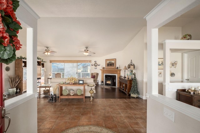 living room with a warm lit fireplace and lofted ceiling