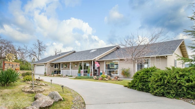 single story home featuring a garage, covered porch, and driveway