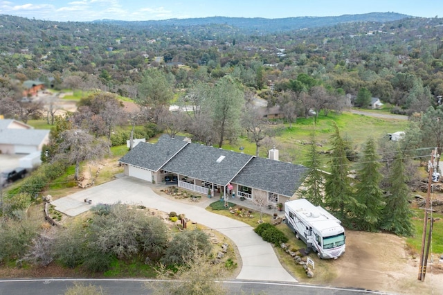 birds eye view of property with a view of trees