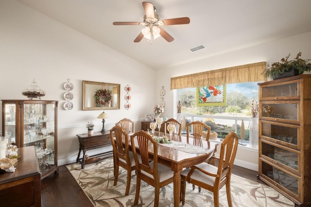 dining space featuring visible vents, ceiling fan, baseboards, vaulted ceiling, and light wood-style floors