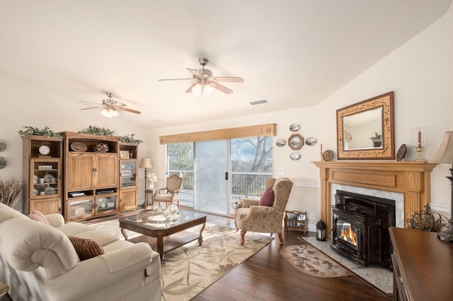 living area with visible vents, light wood-style floors, a ceiling fan, and vaulted ceiling