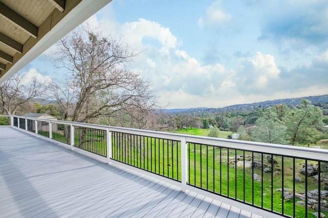 wooden deck featuring a lawn