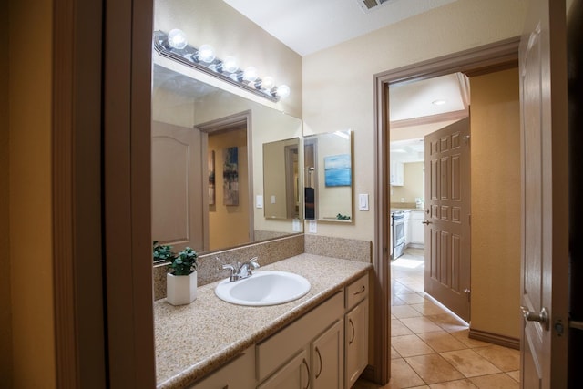 bathroom featuring tile patterned flooring and vanity