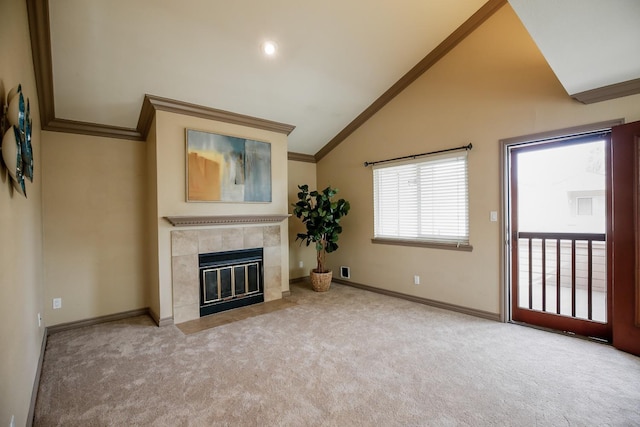 unfurnished living room with ornamental molding, vaulted ceiling, light carpet, and a fireplace