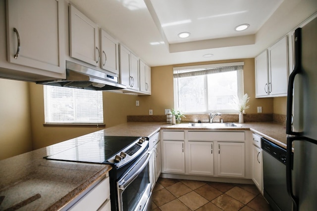 kitchen featuring light tile patterned floors, under cabinet range hood, a sink, white cabinetry, and appliances with stainless steel finishes