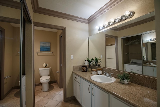 bathroom with washer / dryer, toilet, ornamental molding, tile patterned flooring, and vanity