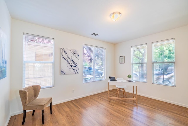 home office featuring baseboards, visible vents, and wood finished floors