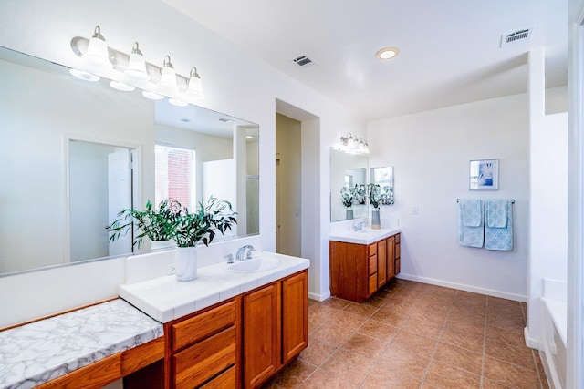 full bathroom with visible vents, two vanities, and a sink