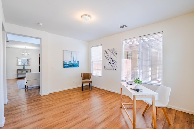 sitting room featuring a chandelier, baseboards, visible vents, and light wood finished floors