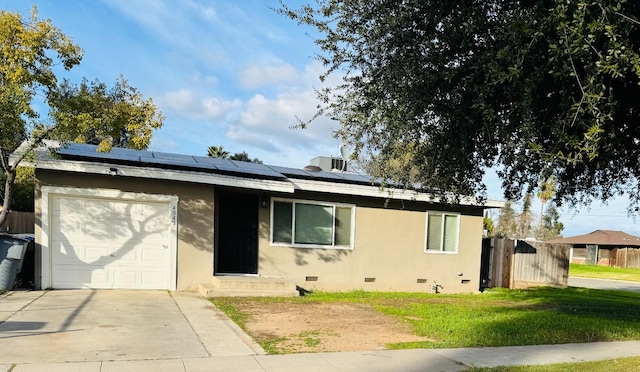 view of front of house with a garage, solar panels, crawl space, fence, and stucco siding