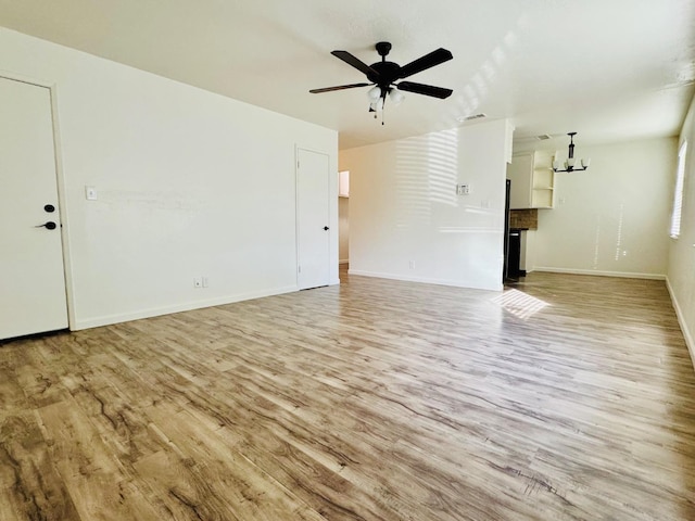 unfurnished living room with baseboards, visible vents, ceiling fan, and light wood finished floors