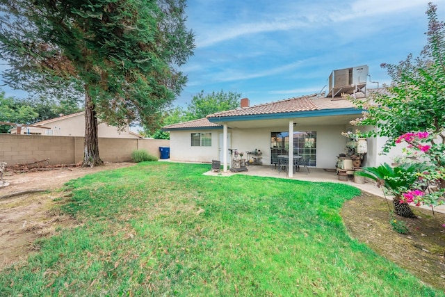 back of property with a patio, fence, a tile roof, a yard, and stucco siding