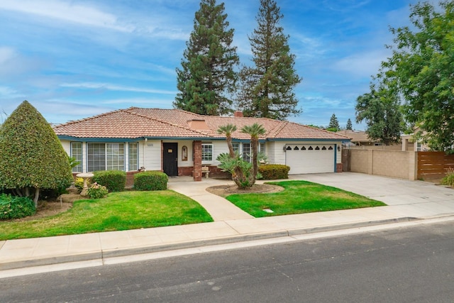 ranch-style home with a garage, a tile roof, concrete driveway, a front lawn, and a chimney