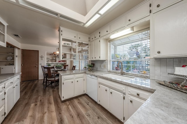 kitchen featuring dishwasher, light countertops, and white cabinets