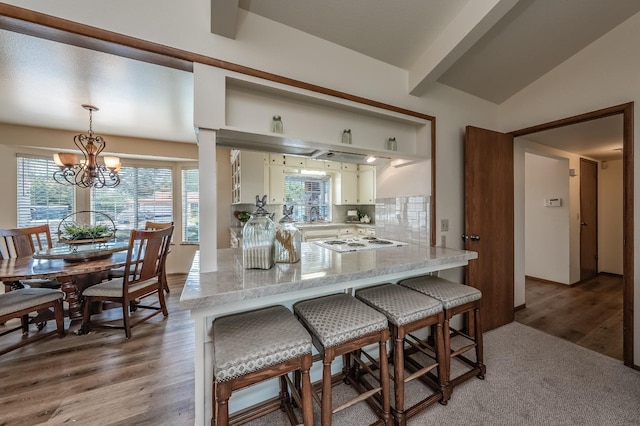 kitchen featuring a peninsula, white electric cooktop, white cabinets, and open shelves