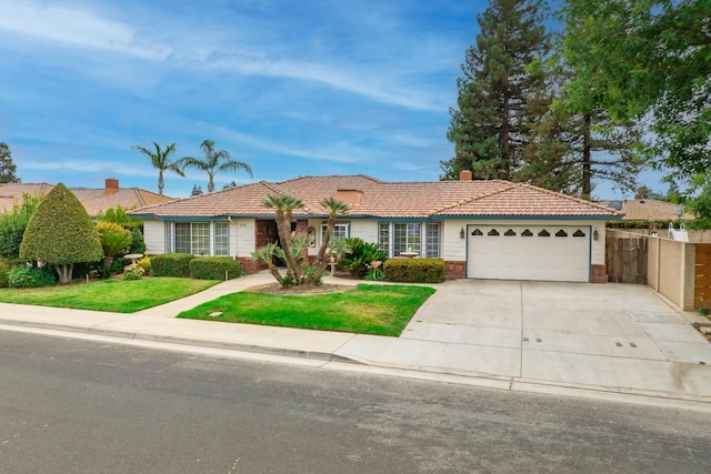 ranch-style house with concrete driveway, an attached garage, a tile roof, and a front yard