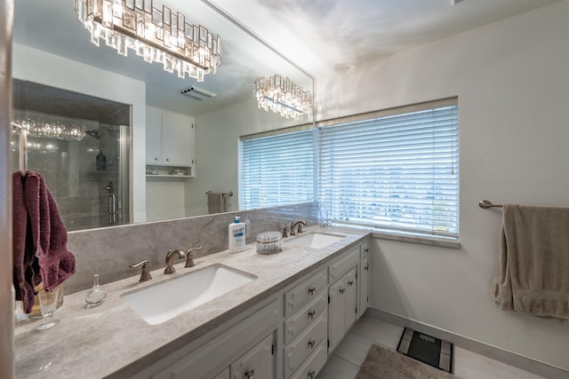 full bath featuring a stall shower, a sink, visible vents, and tile patterned floors