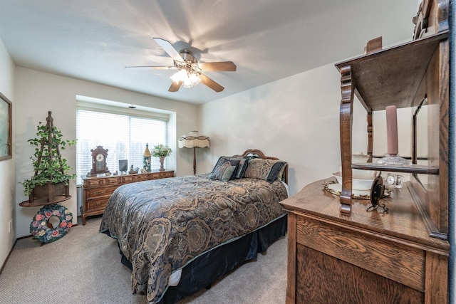 bedroom featuring a ceiling fan and light colored carpet