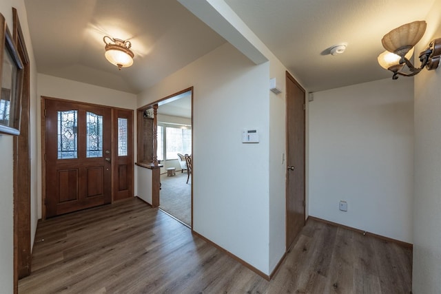 entryway with baseboards and wood finished floors