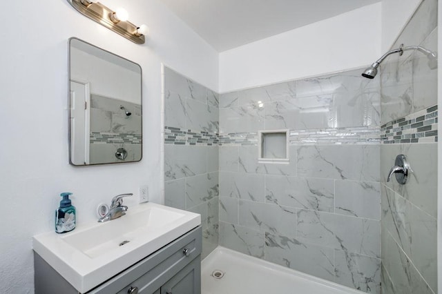 full bath featuring vanity and a shower stall