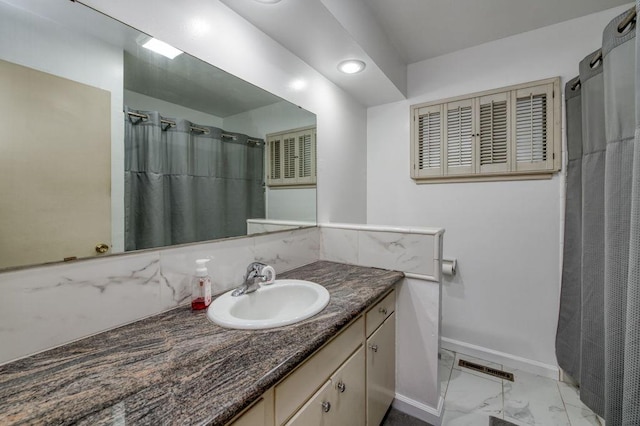 full bathroom featuring baseboards, visible vents, marble finish floor, curtained shower, and vanity