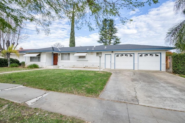 single story home with a garage, a front yard, and concrete driveway