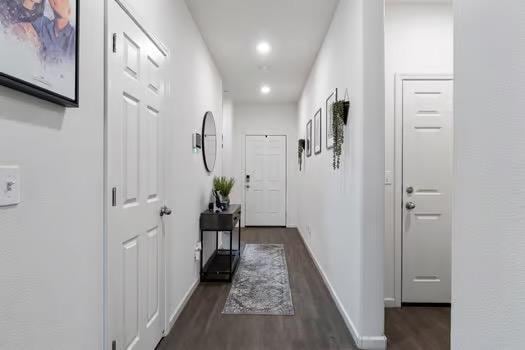 hall with recessed lighting, dark wood finished floors, and baseboards