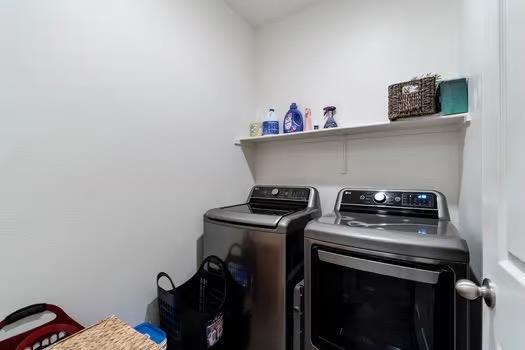 washroom with laundry area and separate washer and dryer