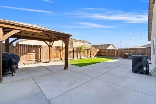 view of patio / terrace featuring a gazebo, a fenced backyard, central AC, and area for grilling