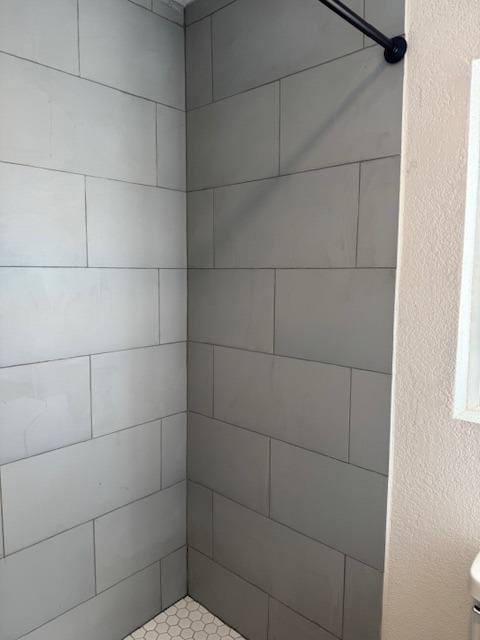 full bathroom featuring tiled shower