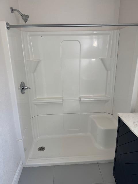 bathroom featuring a stall shower and vanity