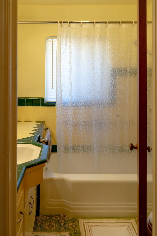 bathroom with vanity and tile walls