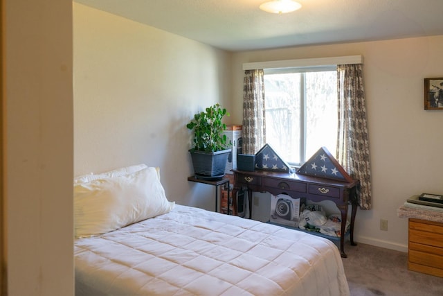 bedroom featuring carpet floors and baseboards