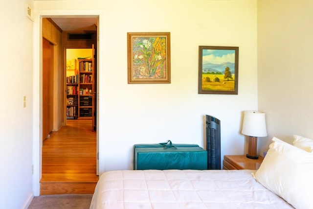 carpeted bedroom featuring visible vents