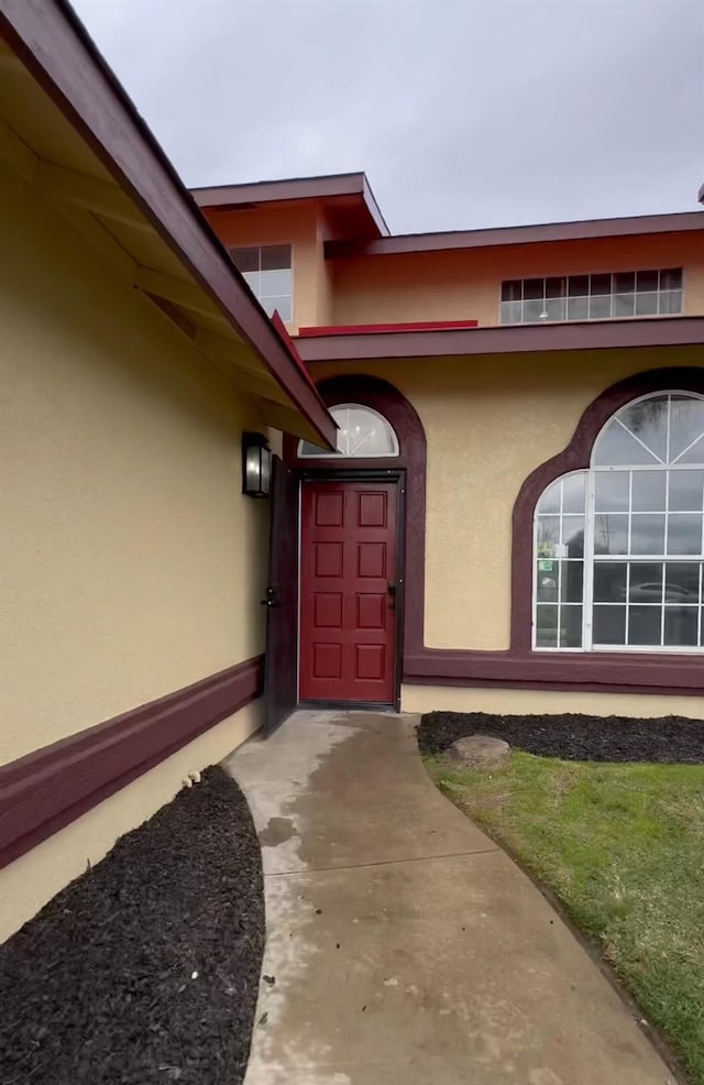 view of exterior entry featuring stucco siding