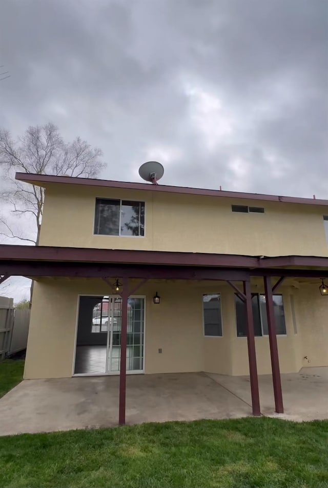 back of house with a patio area and stucco siding