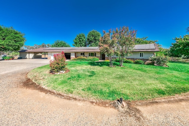 ranch-style home with driveway, a front lawn, and stucco siding