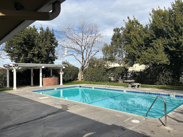 view of pool with a fenced in pool, a patio area, and a pergola