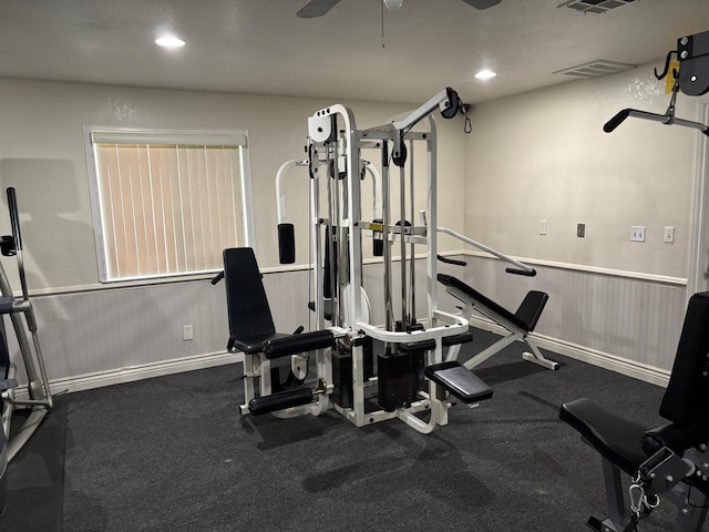 exercise area featuring ceiling fan, recessed lighting, visible vents, baseboards, and wainscoting