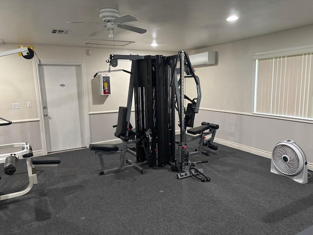 exercise area featuring a wall unit AC, recessed lighting, visible vents, ceiling fan, and baseboards