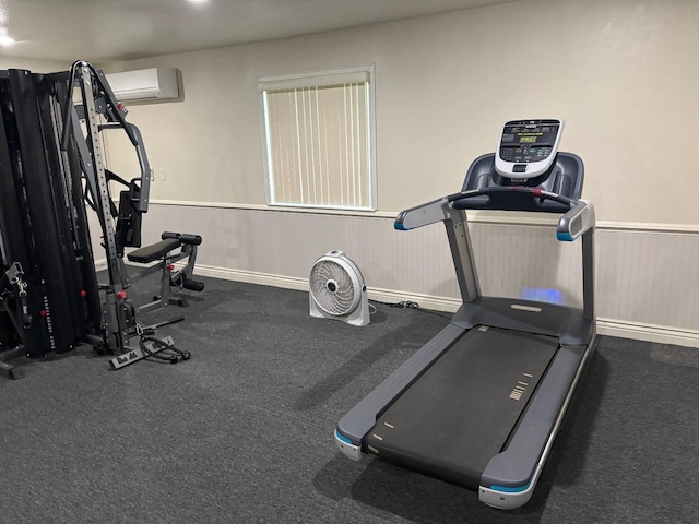 workout room featuring a wall mounted air conditioner and wainscoting