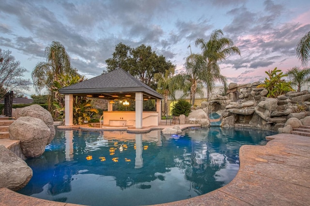 pool featuring a gazebo, a patio area, fence, and a jacuzzi