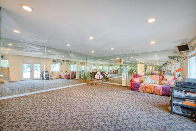 exercise room featuring carpet floors, french doors, and recessed lighting