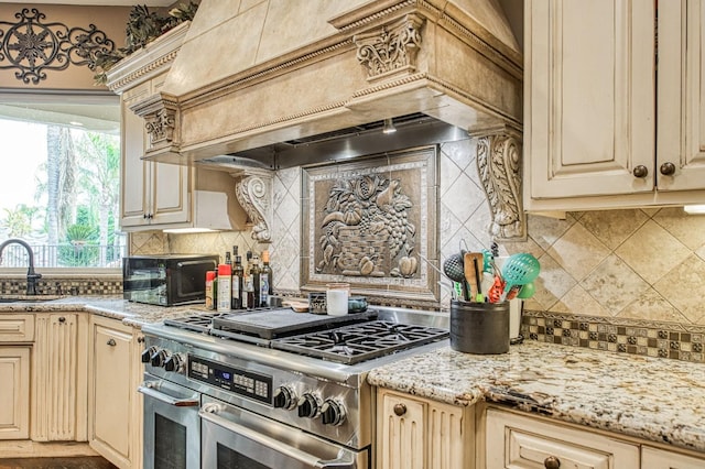 kitchen with a toaster, double oven range, custom exhaust hood, and cream cabinets