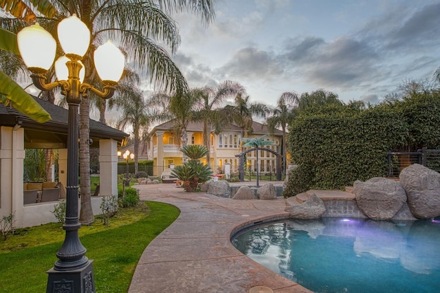 view of pool with a yard, a patio area, fence, and a fenced in pool