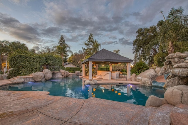 view of swimming pool featuring a fenced in pool, a patio, and a gazebo