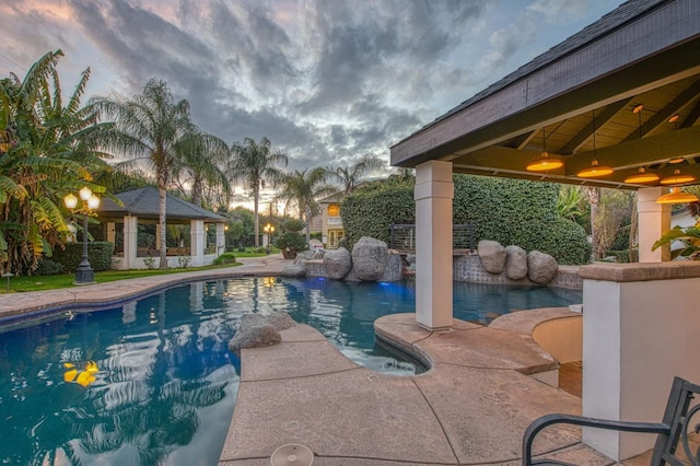 outdoor pool featuring a gazebo and a patio area