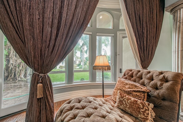 bedroom featuring access to outside, multiple windows, and baseboards